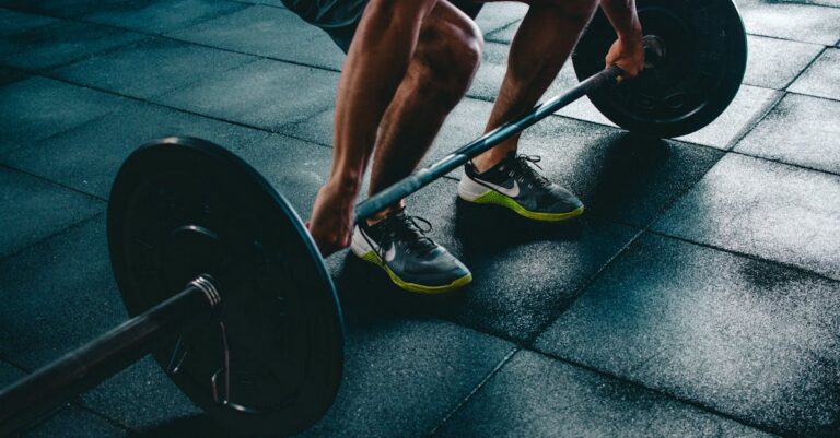 Man performing a deadlift exercise in a gym, demonstrating strength and fitness.